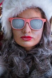 Woman in winter clothes with frosted sunglasses