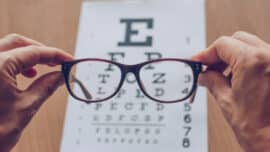 Sight glasses in front of optician sight chart.